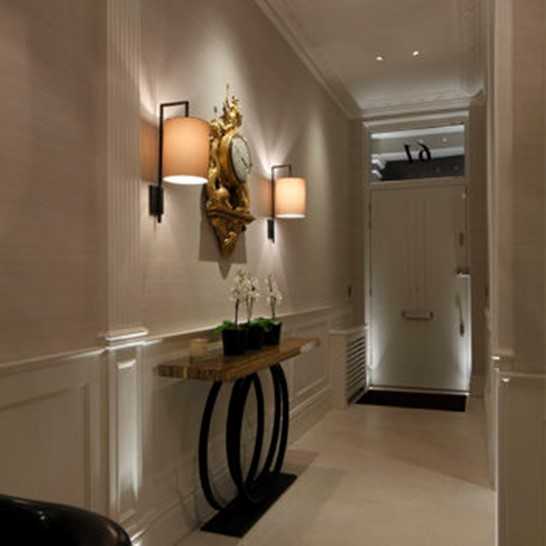 Wall lights in a dark hall - cream lampshades with console table