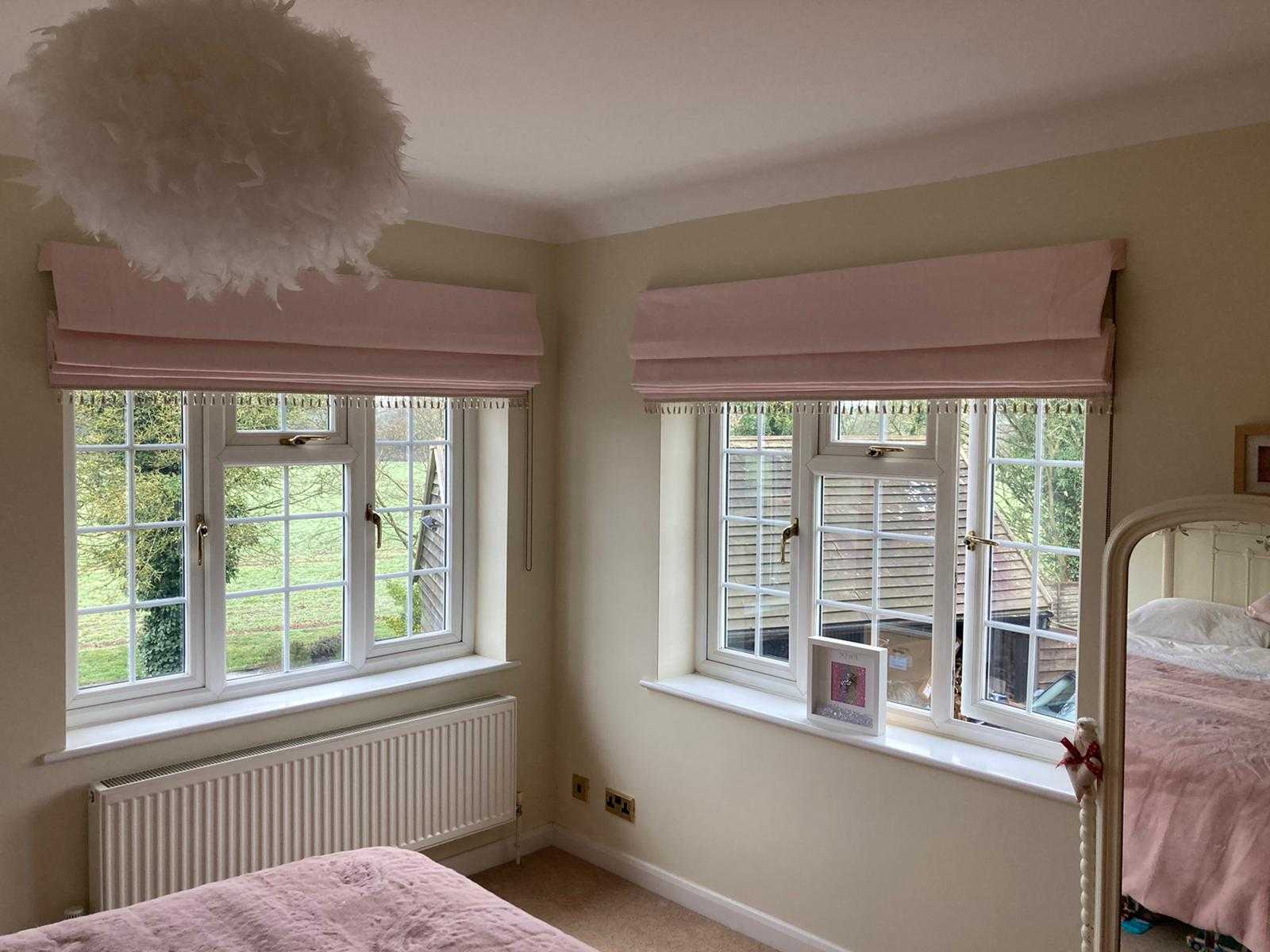 Pink roman blinds with champagne tassle fringe