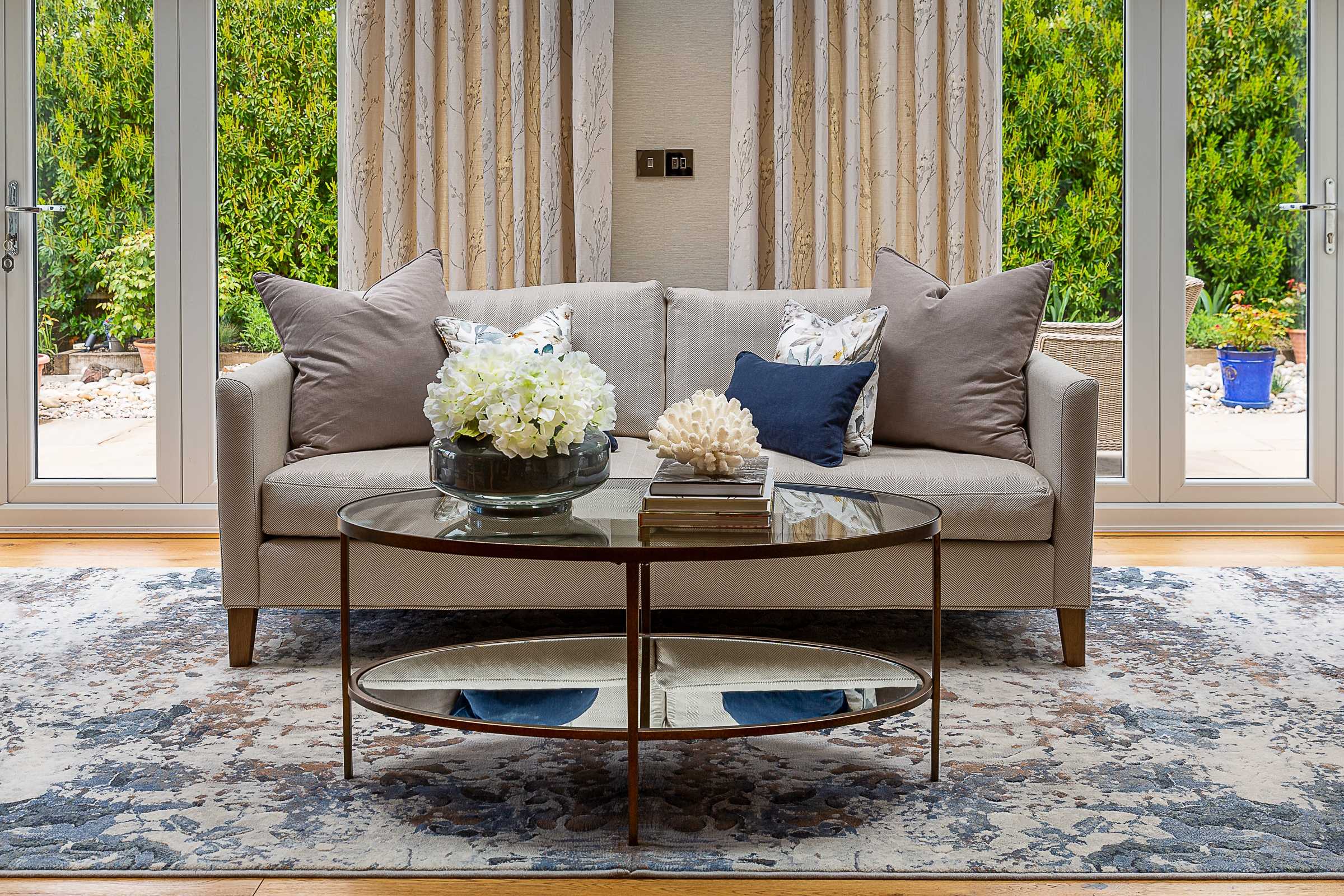 Neutral furniture with navy blue cushions