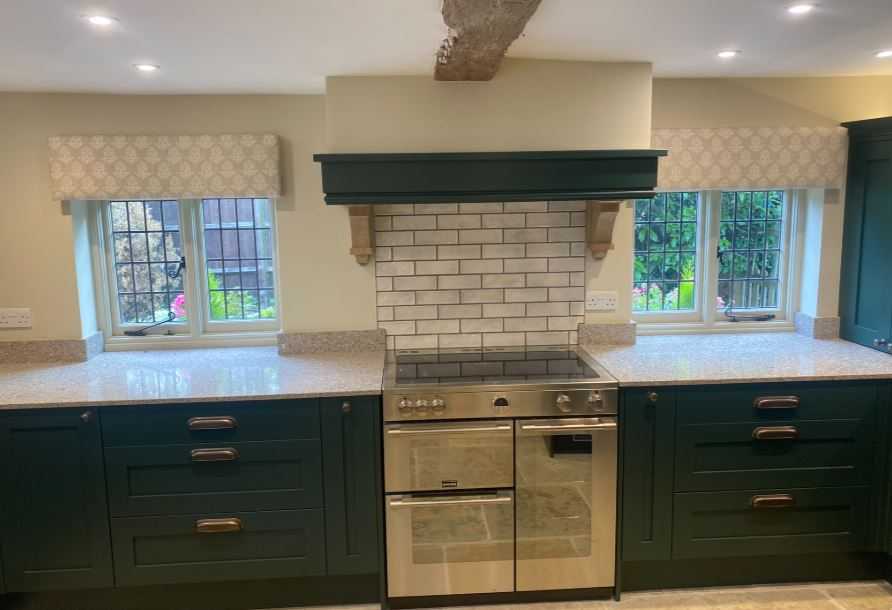 Dark Green kitchen with neutral pelmets