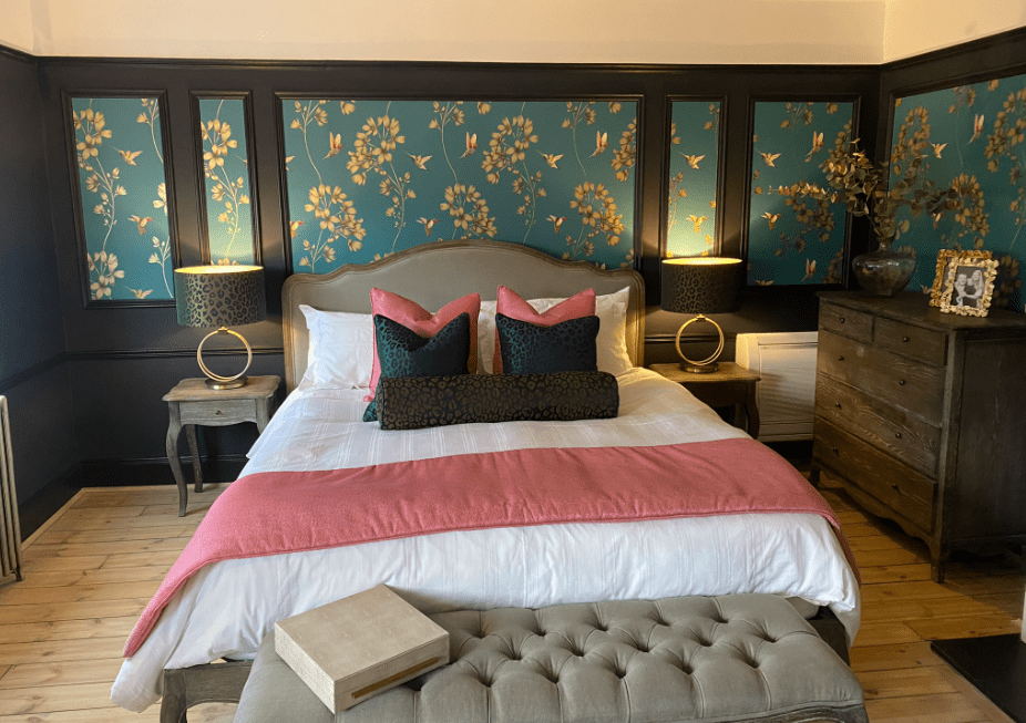 Bedroom with dark wallpapered panels